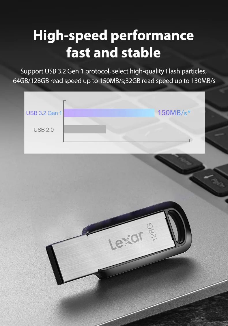 A silver Lexar USB flash drive is shown resting on a dark gray laptop surface.