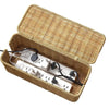Handwoven rattan cable management box with a lid containing white electrical cords and plugs