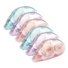 A stack of translucent blue and pink double-sided adhesive tape rollers.
