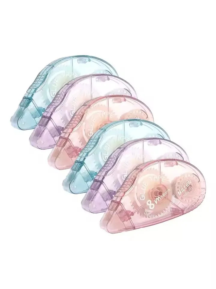 A stack of translucent blue and pink double-sided adhesive tape rollers.