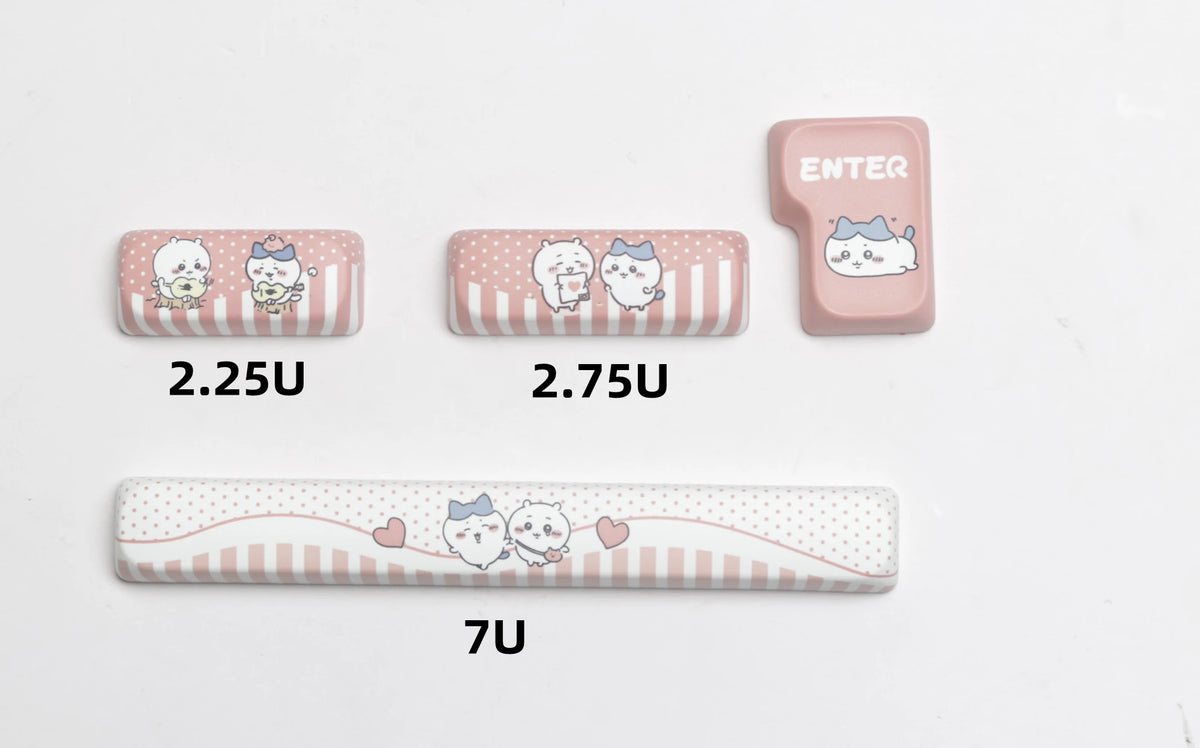 Three pink keycaps and one elongated pink keycap showing various cat designs for mechanical keyboards