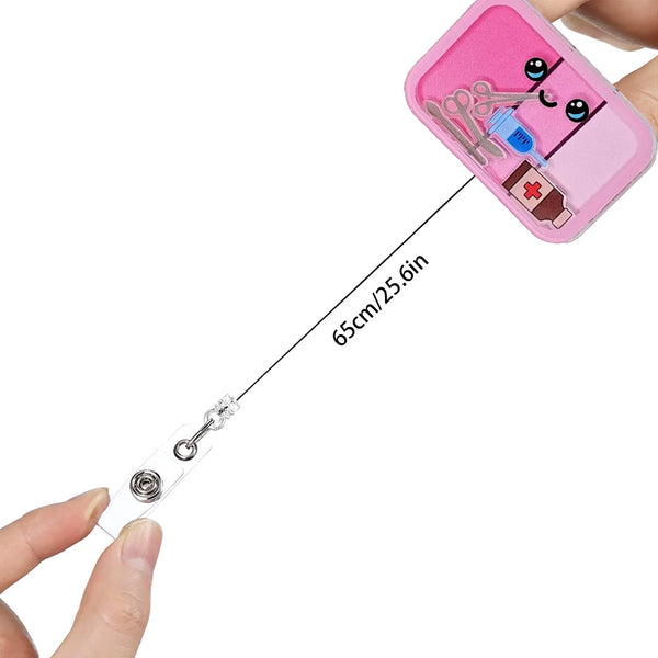A pink badge reel with an anime character design and a medical cross emblem is shown being held by a hand.